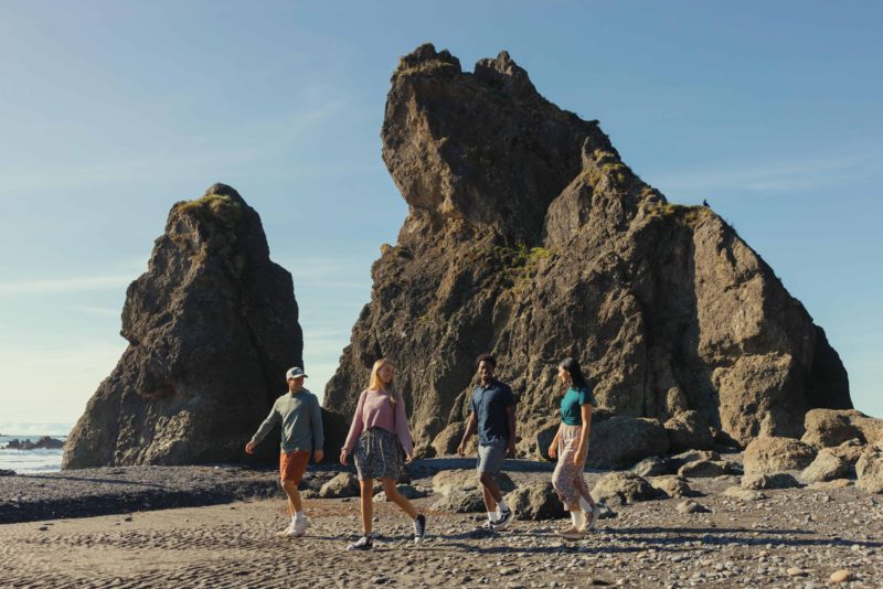 A group of friends wearing tentree Spring 2025 at Ruby Beach, Olympic Peninsula, Washington