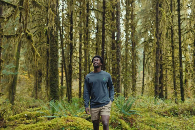 Man wearing tentree Spring 2025 at the Hoh Rainforest in Olympic National Park, Washington