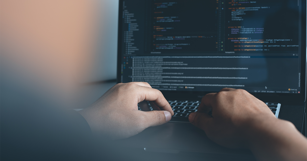 Web developer coding on a laptop while organizing bookmarks with CarryLinks bookmark manager
