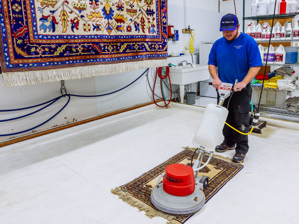 fine fabric care employee performing power clean as part of carpet cleaning service