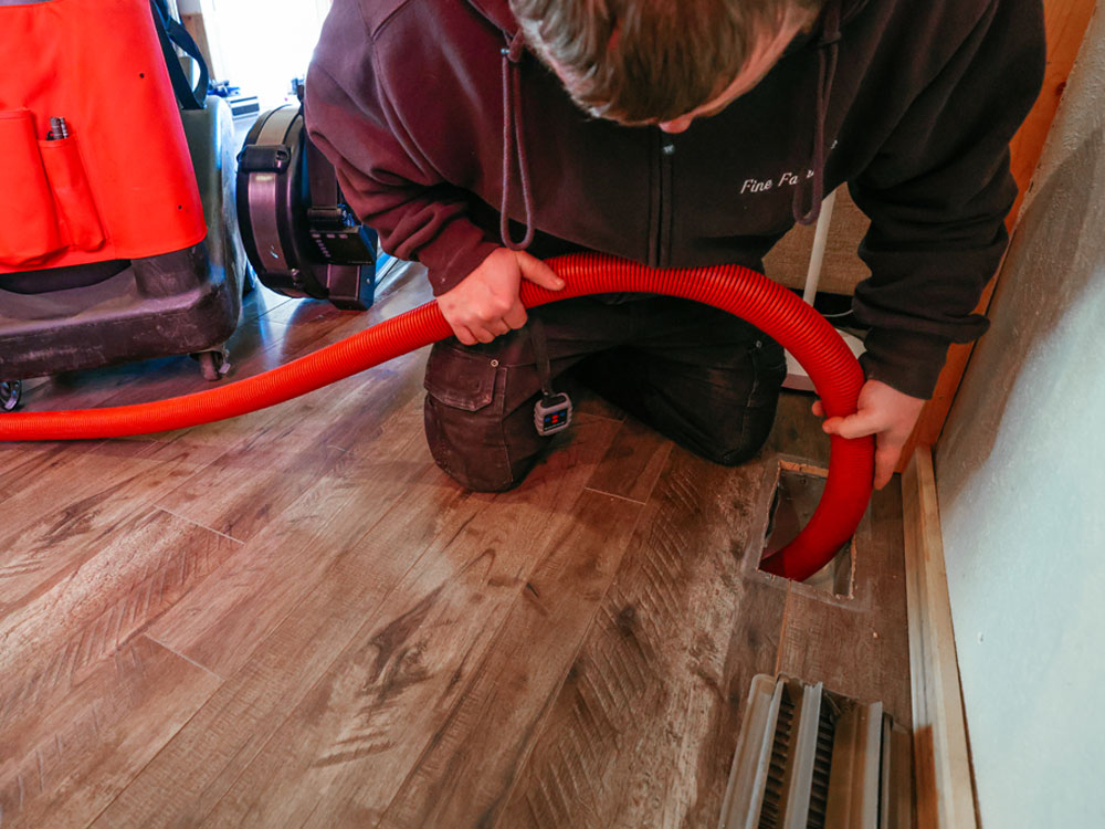 Technician cleaning air ducts in Dillon with a Rotobrush to remove dust and debris