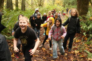 School children on a forest trail in the fall.