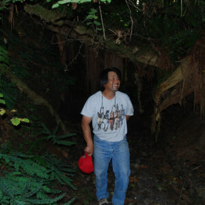 Smiling man in jeans and t shirt in the woods