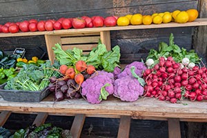 Colorful vegetables arranged on table and shelves