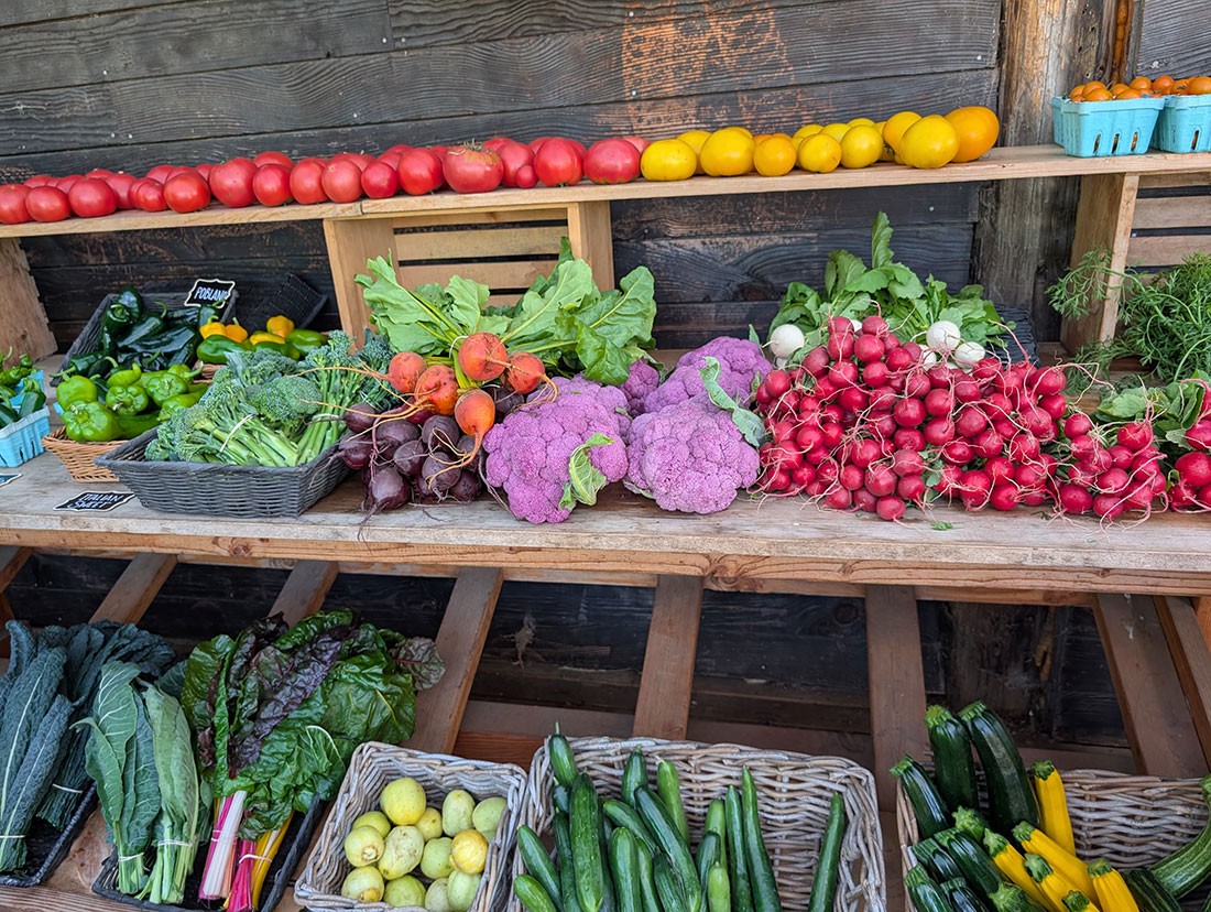 Colorful vegetables arranged on table and shelves