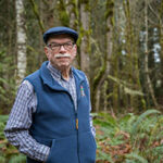 Man posing in front of forest