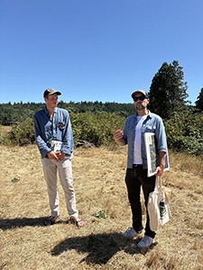 Two men standing in a field.