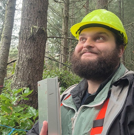 Photo of a man with a beard in a yellow hard hat.
