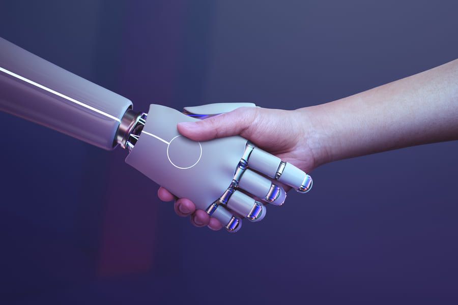 One robot and one human hand shaking each other