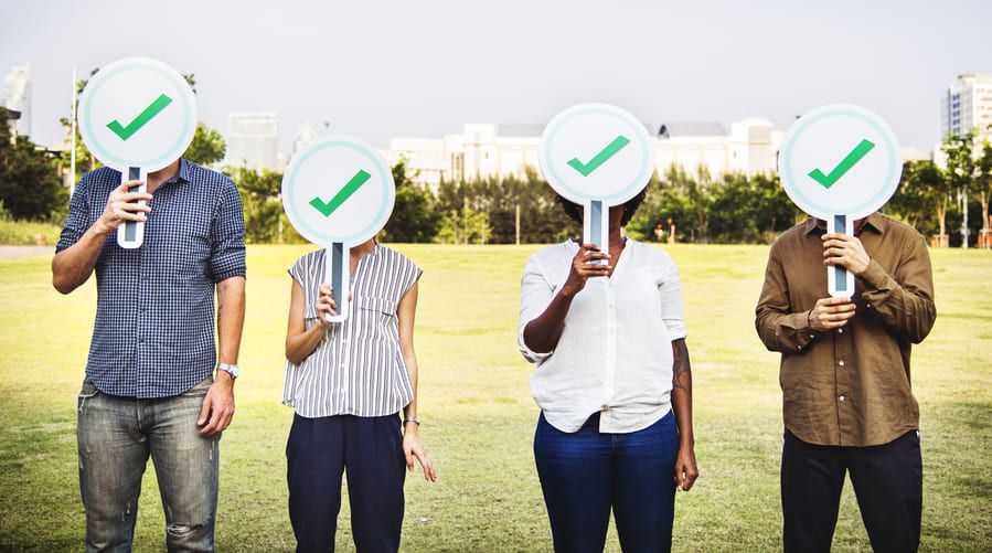 diverse friends holding checkmark icons