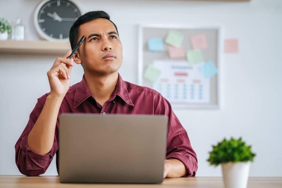man-works-office-thinks-fixing-tasks