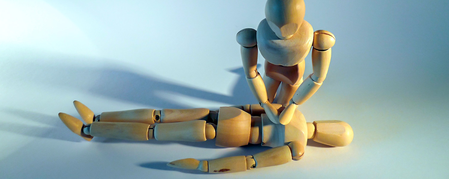 Wooden Mannequins Performing CPR