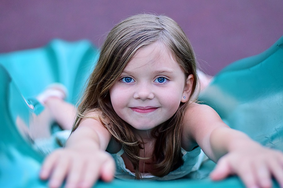 Young girl playing on a slide.