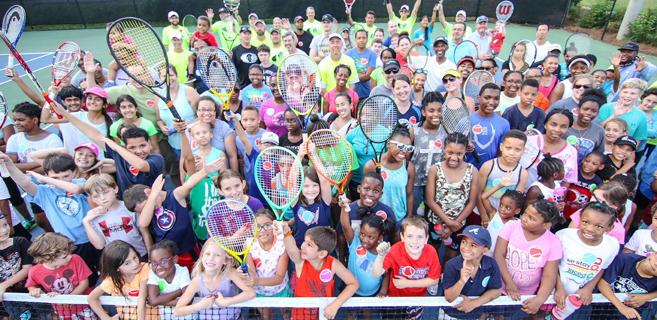 Photo of a large group of tennis players.