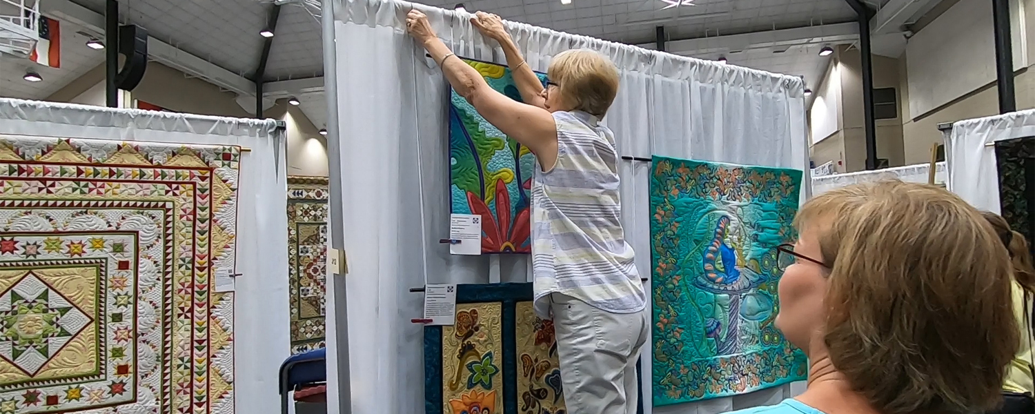 setting up quilts at cobb civic center