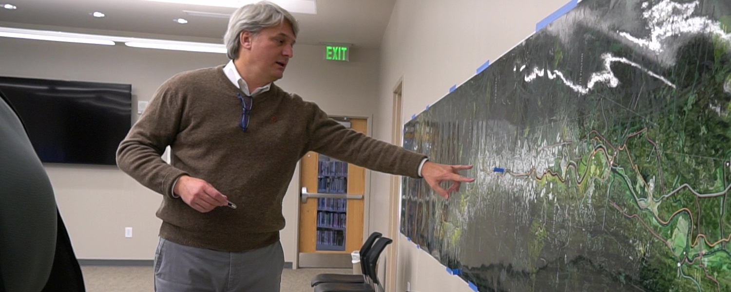 picture of man pointing to map