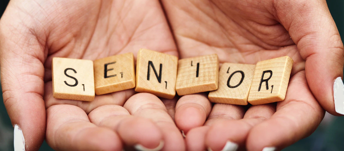 Senior Hands Holding Scrabble Tiles