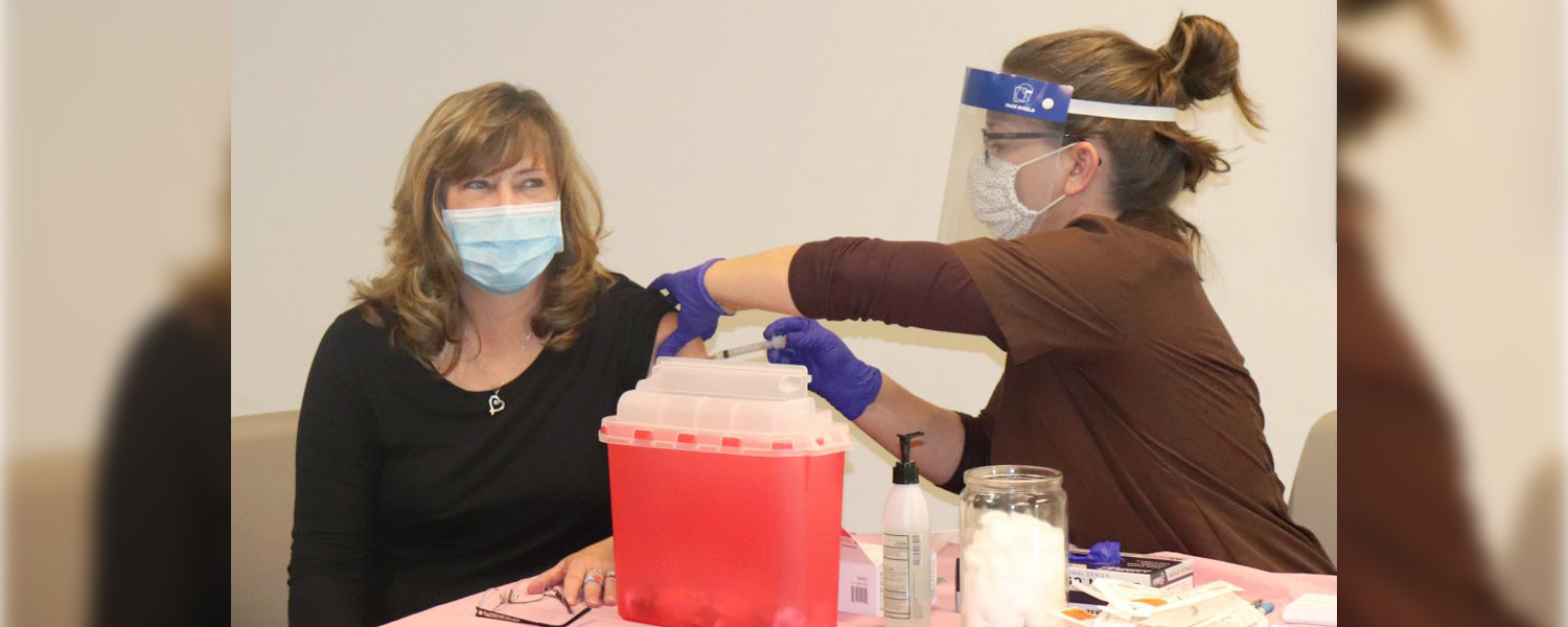 picture of health care worker getting vaccinated