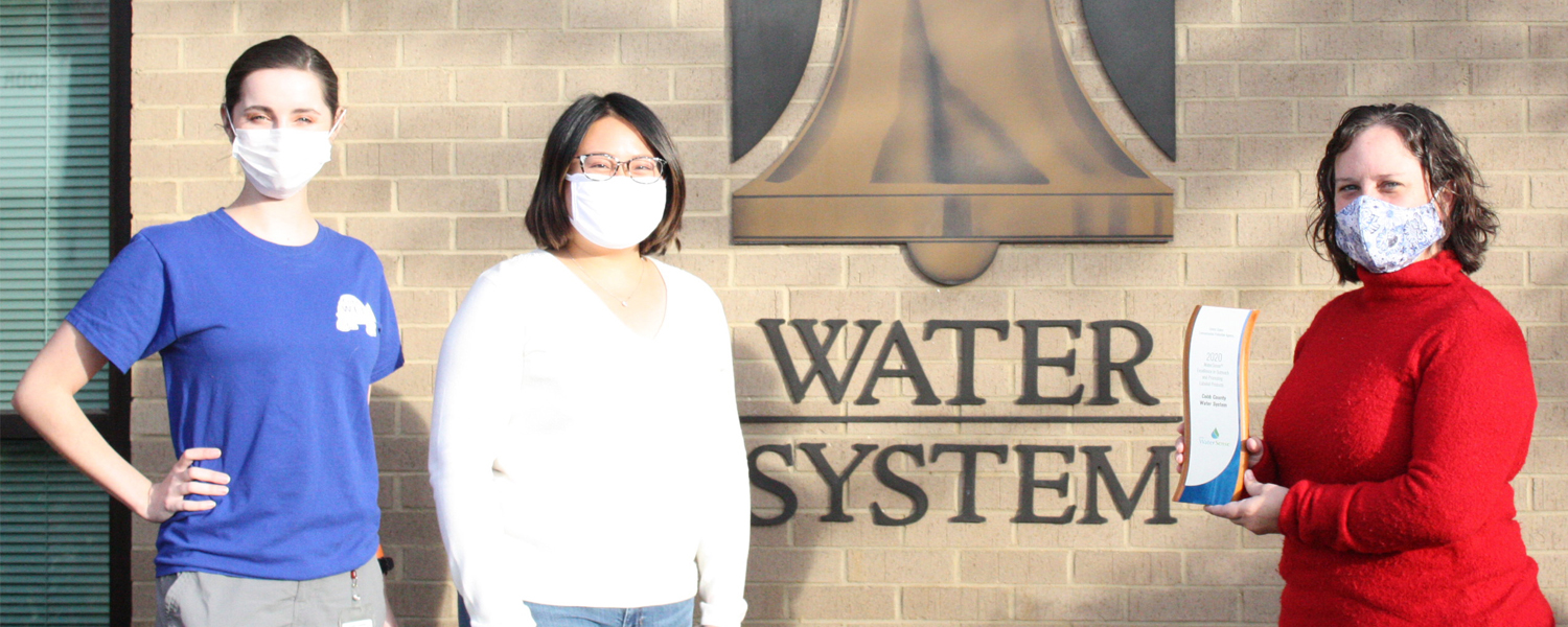 Employees in front of Water System Building