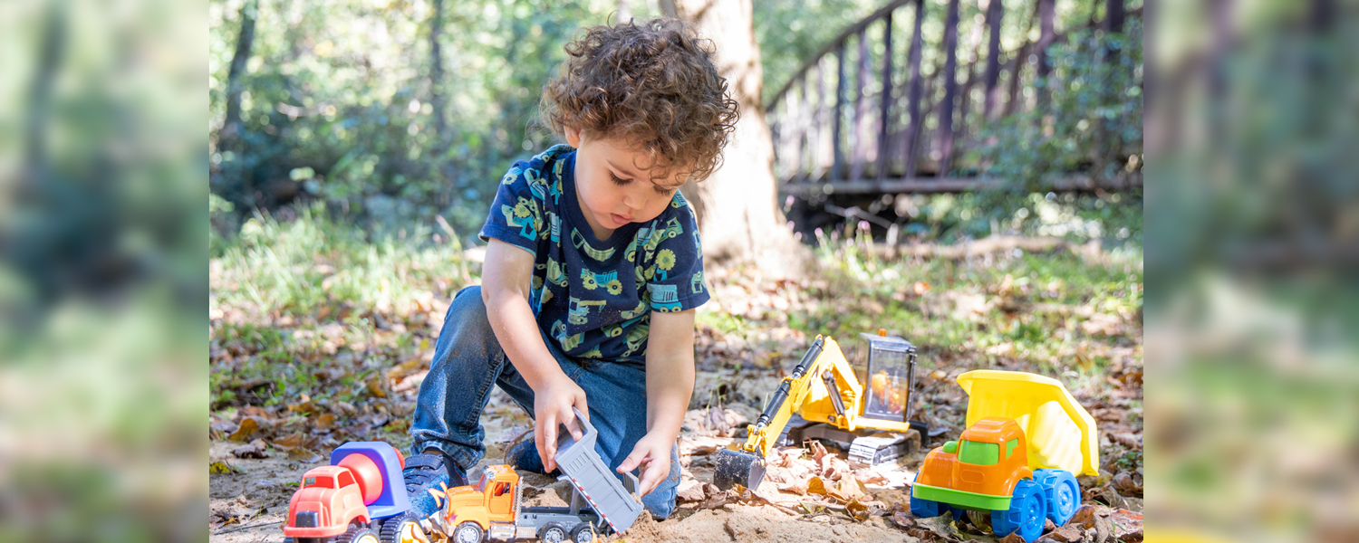 Photo of a child playing with toys in the park.