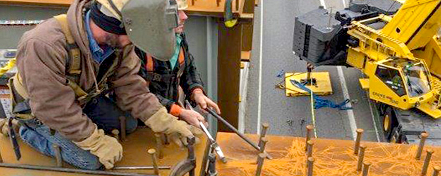 Welders on girders