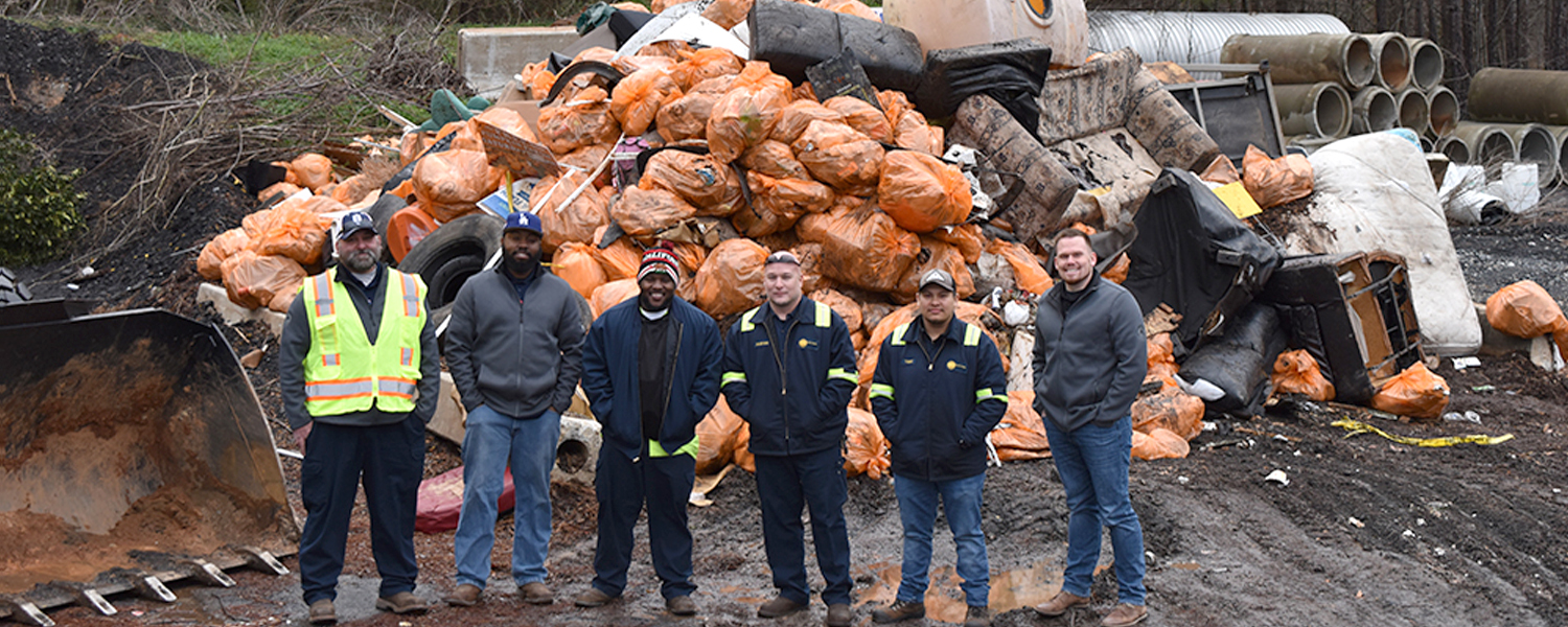 Picture of crew in front of litter picked up over one month in the county