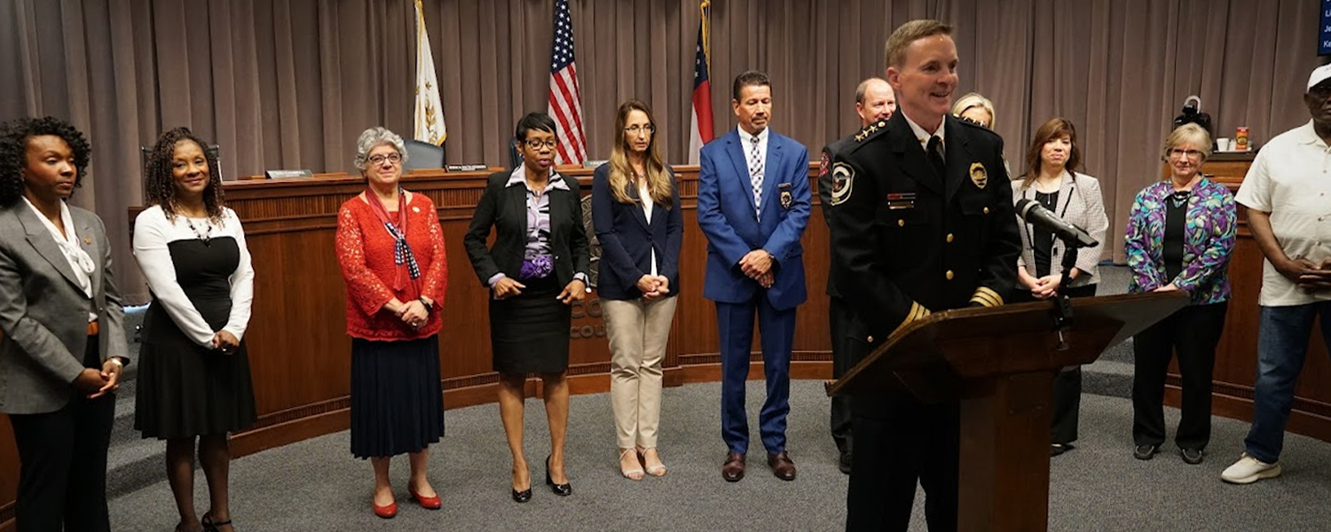 Police Chief Stuart VanHoozer with officials in the background