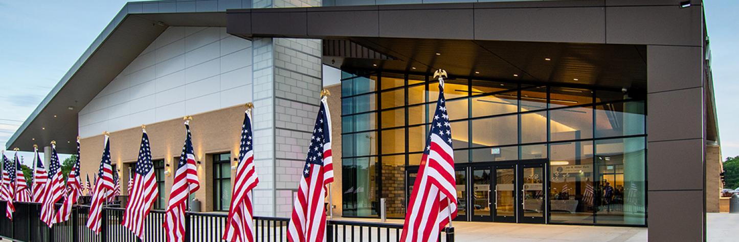 Photo of the Jim Miller Park Event Center with flags.