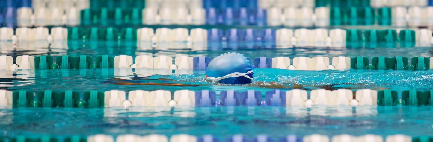 Photo of a child swimming with just head showing.