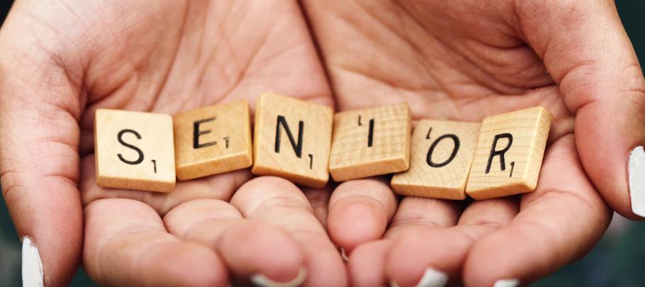Senior Hands Holding Scrabble Tiles