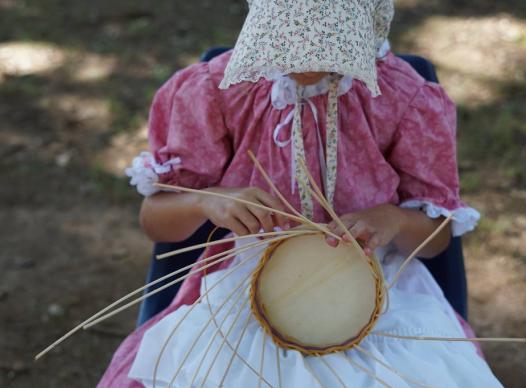 photo of a basket weaver at the Mable House harvest festival