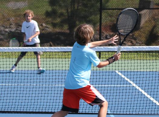 boys playing tennis at Harrison Tennis Center