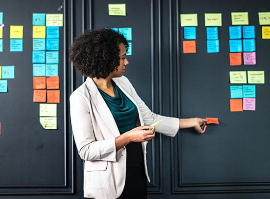 Woman Categorizing Ideas with Sticky Notes