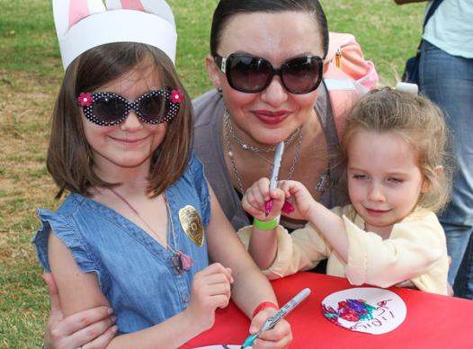 Photo of mother and daughters enjoying the eggstravaganza event.