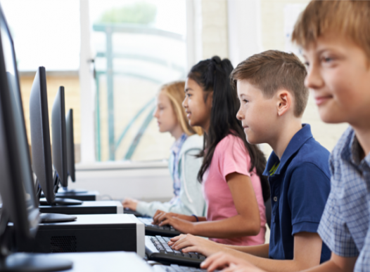 row of elementary school children using computers