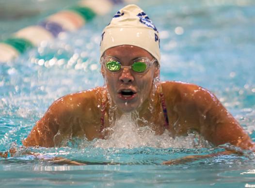 Photo of a male competitive swimmer swimming the butterfly.