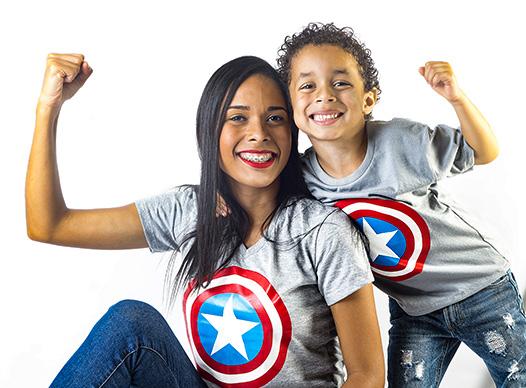 Woman and boy dressed as superheroes