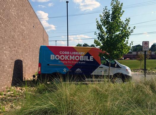 long shot of the Cobb Library Bookmobile in a parking lot