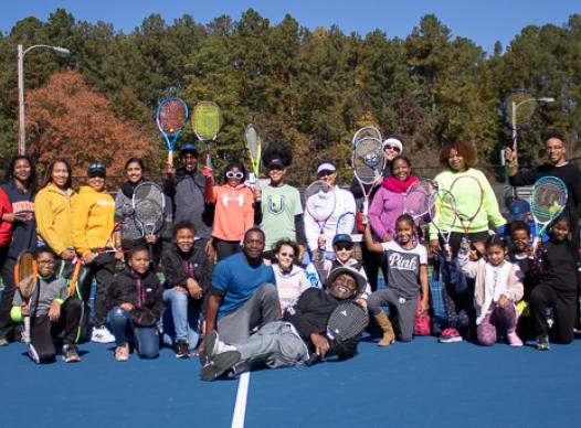 Group of tennis players posing for photo.