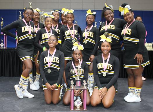 Photo of cheerleaders with their trophy