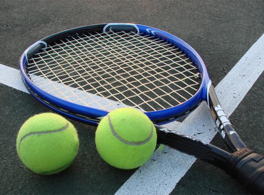 Photo of a tennis racket and tennis balls