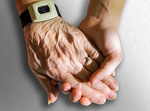 Young woman holding senior's hand