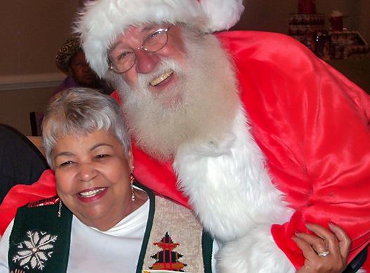 Santa hugging senior
