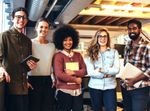 diverse group of young men and women standing side by side, smiling