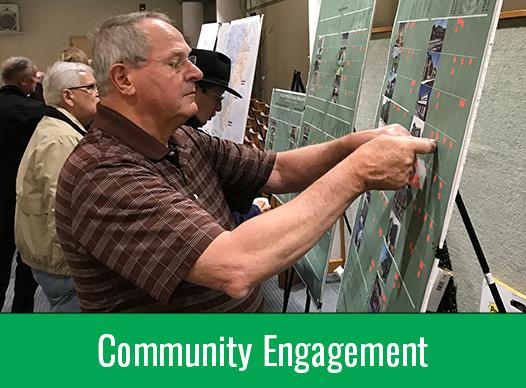 Man putting sticker on board | Community Engagement