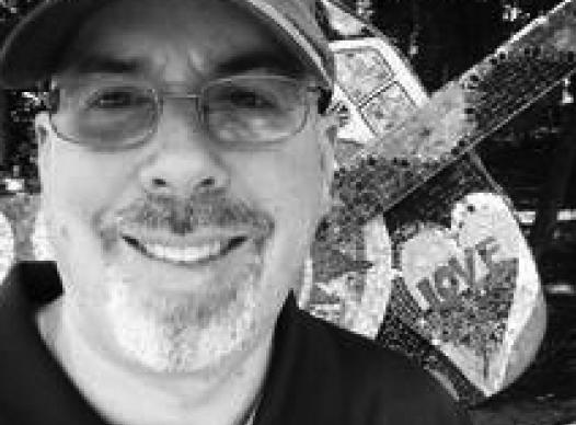 black and white image of man wearing ballcap and glasses