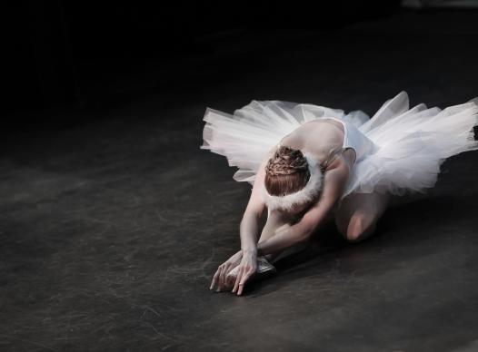 Ballerina posed head down arms stretched out