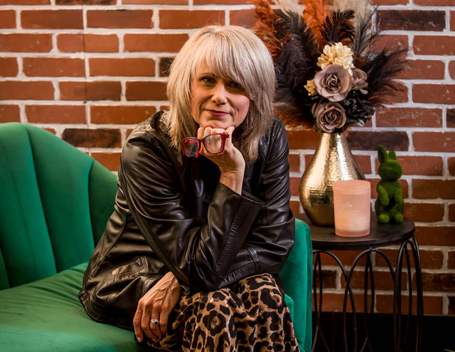 woman sitting on a green sofa
