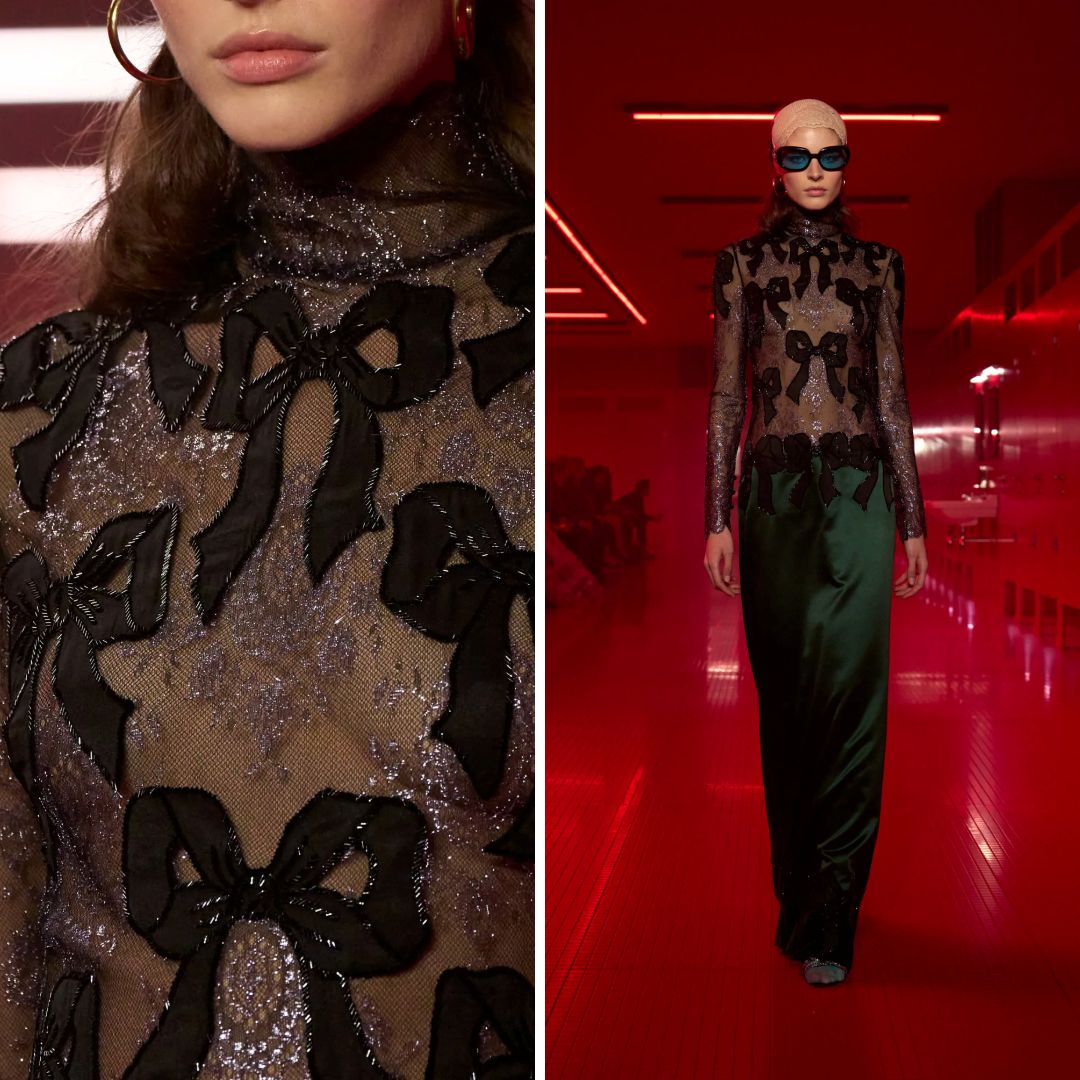 Detail and runway shot of a sheer black tulle blouse from Valentino Fall 2025, featuring large organza bow appliqués and subtle metallic embellishment.