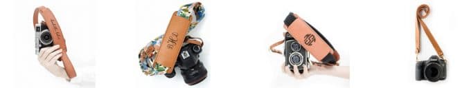 Light tan personalized camera strap and black camera being held by a hand to show gifts for photographers.